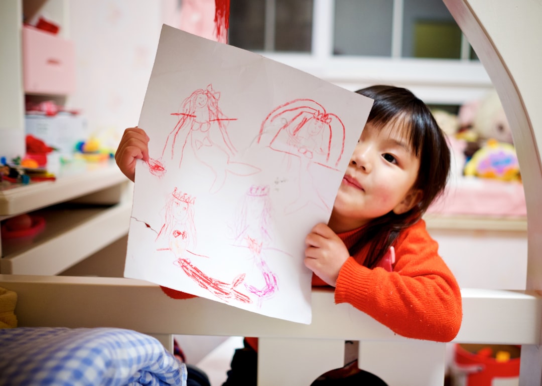 child drawing wall